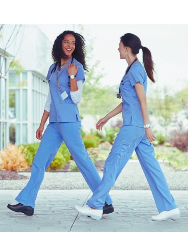 Two nurses wearing nurse shoes for back pain and wearing blue dresses walking and happily talking